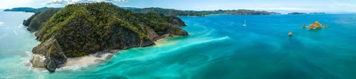 Aerial view, tropical islands and sailing boat in the turquoise ocean, Tortuga Island, Puntarenas,