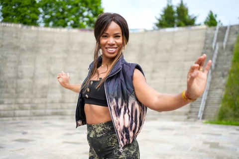 Sensual female latin dancer moving following cuban salsa in a park