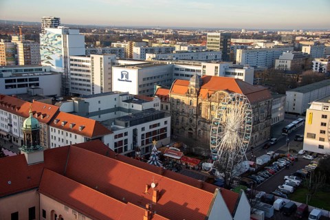 High-rise buildings in the city centre with Ferris wheel at the Christmas market, Magdeburg,