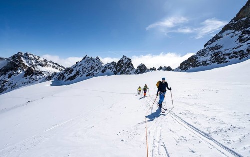 Ski tourer with rope, rope team on the Vadret da Porchabella glacier on the ascent to the summit of