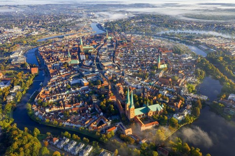 Aerial view over the river Trave and old town and churches of the Hanseatic City of Lübeck in the