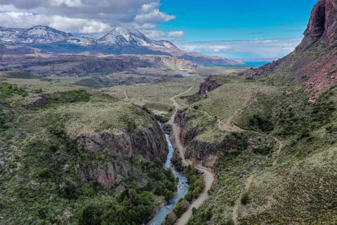 Canyon of river Rio Claro, gravel road along the river, view towards mountain range at Puerto