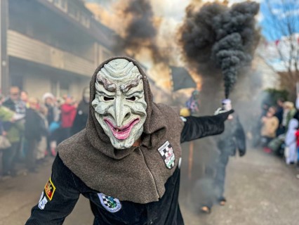 Portrait of Hofener Hogamale with smoke bomb at the big carnival parade of the Hofener