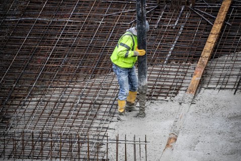 Construction site, concreting, the foundation of a building is concreted, the concrete is pumped