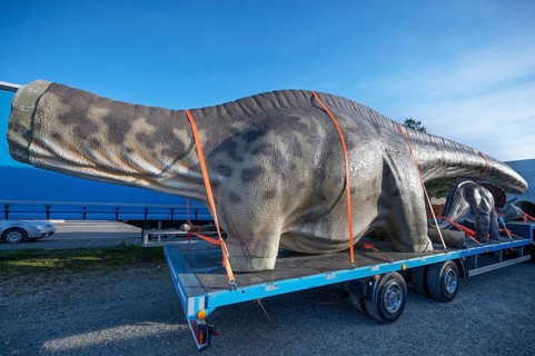 Large dinosaur figure loaded in parts on a heavy goods vehicle, Lauf an der Pegnitz, Middle