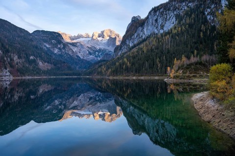 The Vordere Gosausee lake in autumn with a view of the Dachstein mountain range. The Gosaukamm on
