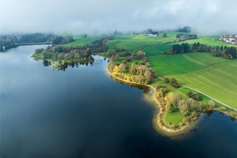 Sports facility and bathing area, lake Rottachsee, shore covered with fog, autumn, aerial view,