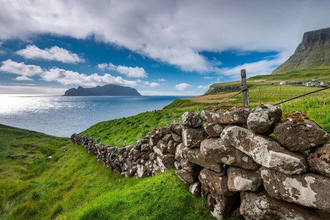 View of the island of Mykines, old stone wall, Gásadalur village, Vágar, Faroe Islands, Denmark,