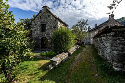 View of the village, typical Ticino stone houses in the mountain village of Rasa, Centovalli,