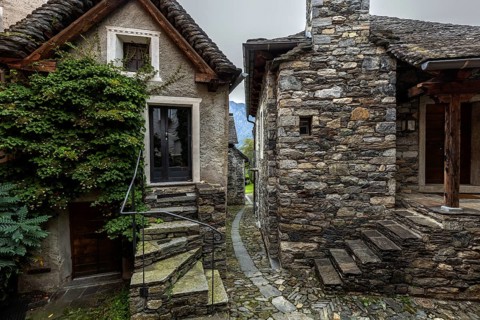 Typical Ticino stone houses in a narrow alley in the mountain village of Bordei, Centovalli, Canton