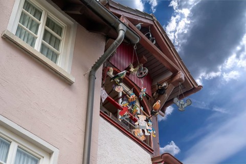Historic roof lift bay window decorated with colourful figures, Villingen-Schwenningen,