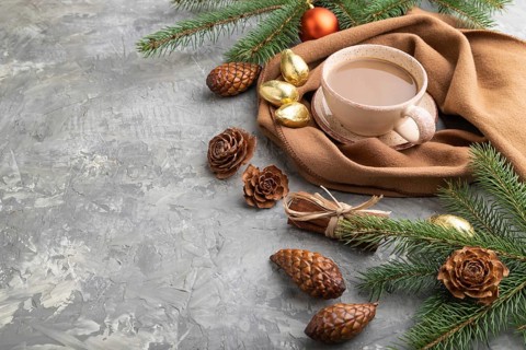 Christmas or New Year composition. Decorations, cones, cinnamon, fir and spruce branches, cup of
