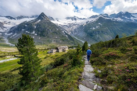 Mountaineer barefoot on a hiking trail, mountain hut Berliner Hütte, mountain peak Steinmandl,