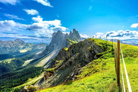 Majestic peaks of seceda rise above lush green valleys and meadows in the italian dolomites, a