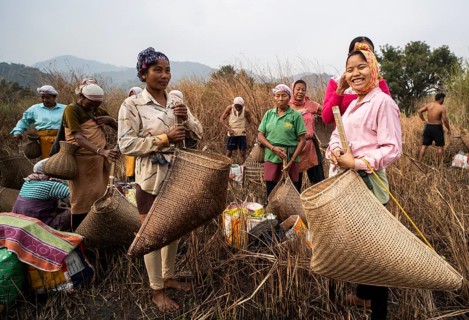 Villagers participate in a community fishing event on the occasion of the Bhogali Bihu festival at
