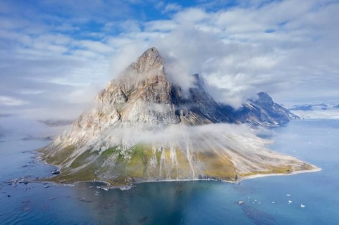Gnalberget, mountain with steep sea cliffs in Hornsund fjord at Gnålodden in summer, Svalbard,