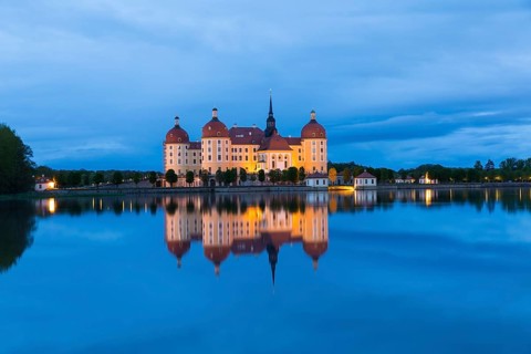 Moritzburg Hunting Lodge with reflection in the castle pond in the evening, Moritzburg, Saxony,