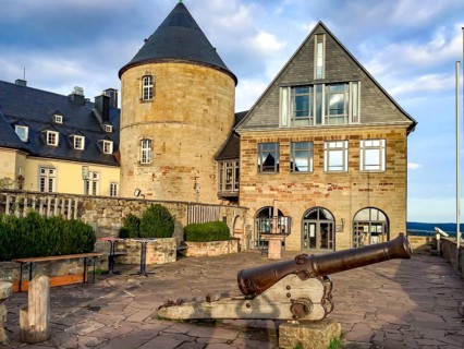 View from Altane to historical cannon in the foreground behind it on the right entrance to torture