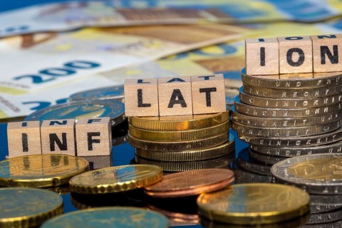 Symbolic image of inflation: euro coins and letters displaying the word INFLATION