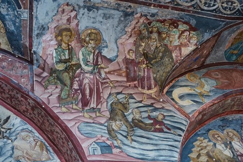 Historical fresco with a biblical scene of people in the water, surrounded by other biblical