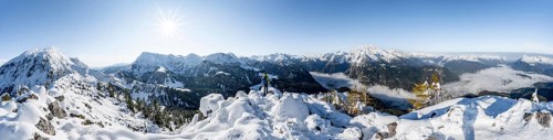 Panorama, mountaineer on the snowy summit of the Jenner in autumn, view of the sea of clouds and