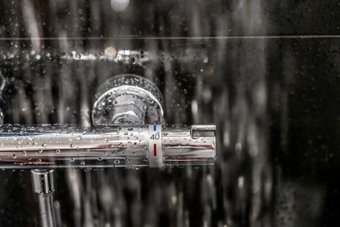 Shower, fitting, temperature control, temperature control of the shower water