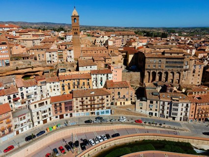 Aerial view of a historic city with a striking tower and many tiled roofs, aerial view, church,