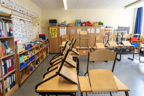 Classroom of a fourth grade, after school, the building is older but in good condition, modern