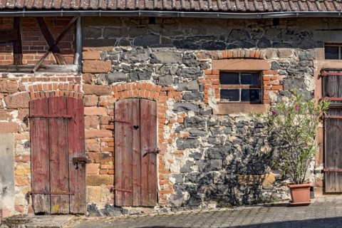 Historic farmhouse around 1800, half-timbered façade, sandstone, natural stone, brick, weathered