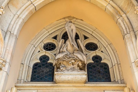 Pelican as a Christian symbol above the entrance gate to the Jakobikirche, Freiberg, Saxony,