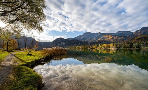 On the shore of Lake Lake Kochel with reflection, autumn landscape with mountain peaks Herzogstand