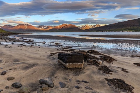 Fjord, low tide, stones, mountains, evening light, cloudy mood, Thingeyri, Westfjords, Iceland,