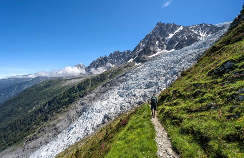 Hiking on the trail to La Jonction, Glacier des Bossons, behind the summit of the Aiguille du Midi,