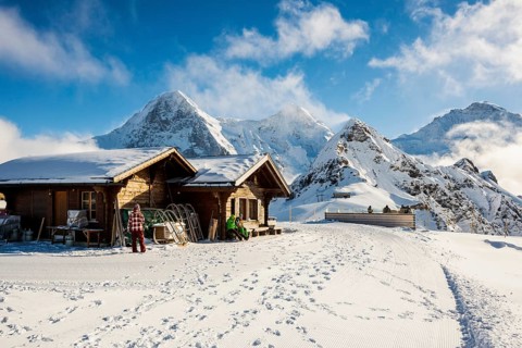 Wooden chalet and ski slope, with views of the Eiger, Mönch and Tschuggen, Grindelwald, Bernese