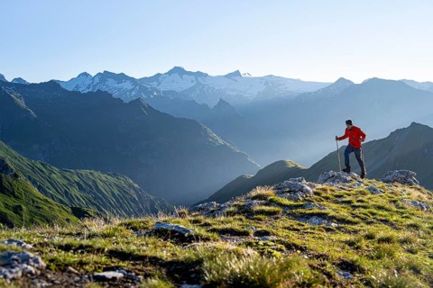 Hiker enjoying the mountain panorama in the morning, Venediger group, behind Dreiherrenkopf,