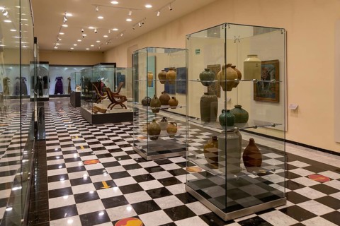 Interior of city museum, Campeche city, Campeche State, Mexico display cabinets of pottery and