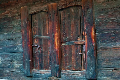 Closed wooden window shutter. Historic village of Mühlebach, Valais, Switzerland, Europe