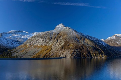 Kölnbrein reservoir and the Oberlecherspitzen mountain on a bright sunny morning. Seen from the