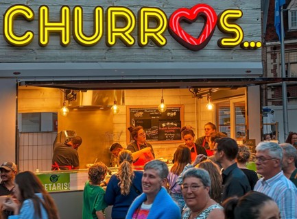 Churros stall selling fried choux pastry dough during the Gentse Feesten, Ghent city festival,