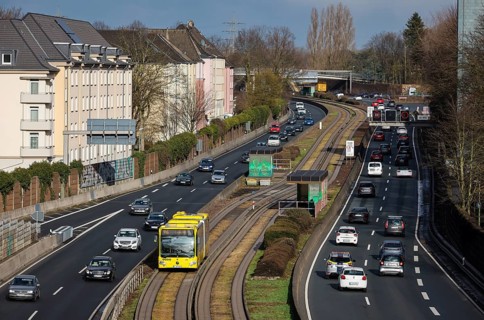 Essen, North Rhine-Westphalia, Germany - Cars and a public bus drive through Essen city centre on