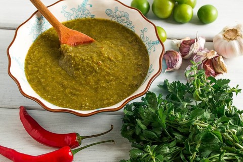 Tkemali sauce, traditional Georgian cuisine, green cherry plum, with ingredients for sauce,