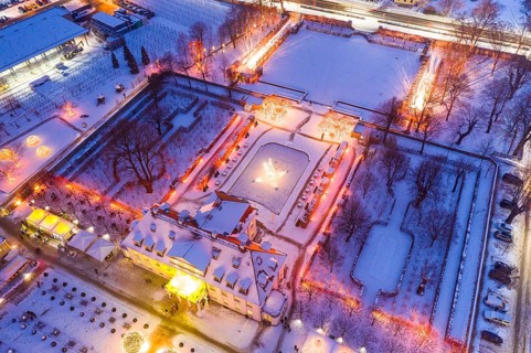 Aerial view of Wackerbarth Castle with castle park in snow and Christmas lights, Radebeul, Saxony,
