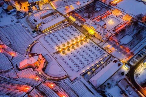 Aerial view of Wackerbarth Castle with castle park, belvedere and vineyards with snow and Christmas