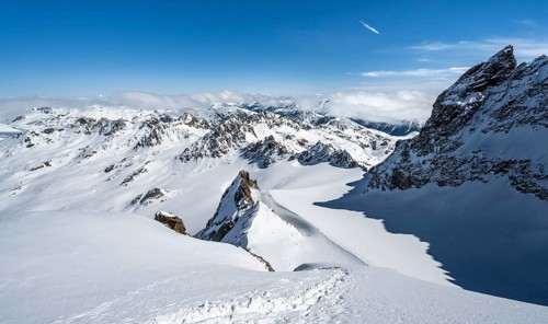 Mountain ridge of Piz Kesch, ascent on Piz Kesch or Piz d'Es-cha in winter, spectacular mountain