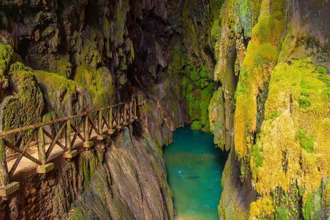 Beautiful colours inside the Iris Grotto at the Cola de Caballo Waterfall in the Monasterio de