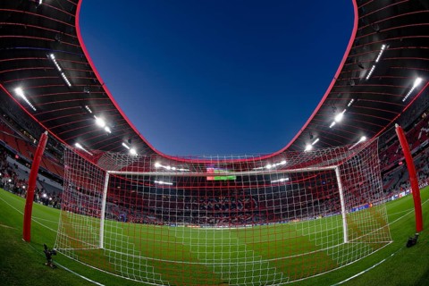 Overview, interior, floodlit match, behind-the-goal perspective, goal net, blue hour, fisheye shot,