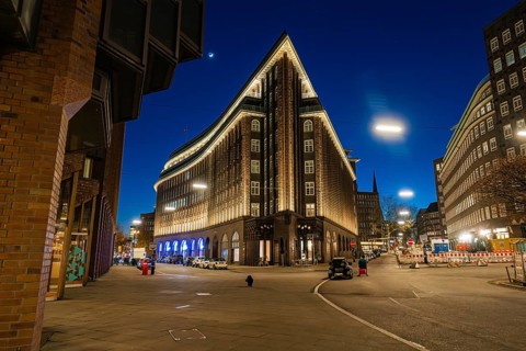 Chilehaus at night, viewed from below, brick façade illuminated, lettering visible, Hamburg,