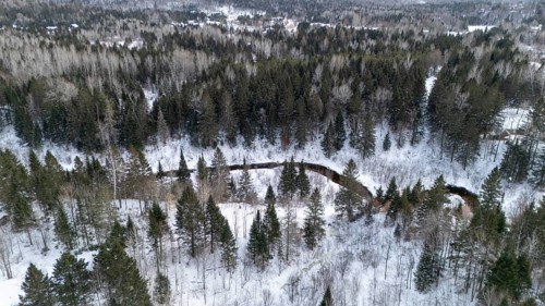 River in the boreal forest in winter. Region of La Mauricie. Province of Quebec. Canada