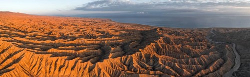 Landscape of eroded hills at Lake Issyk Kul, Badlands at sunrise, aerial view, Canyon of the