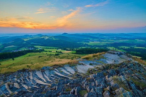Colourful hilly landscape at sunset, showing fields and a dramatically coloured sky, Abtsroder